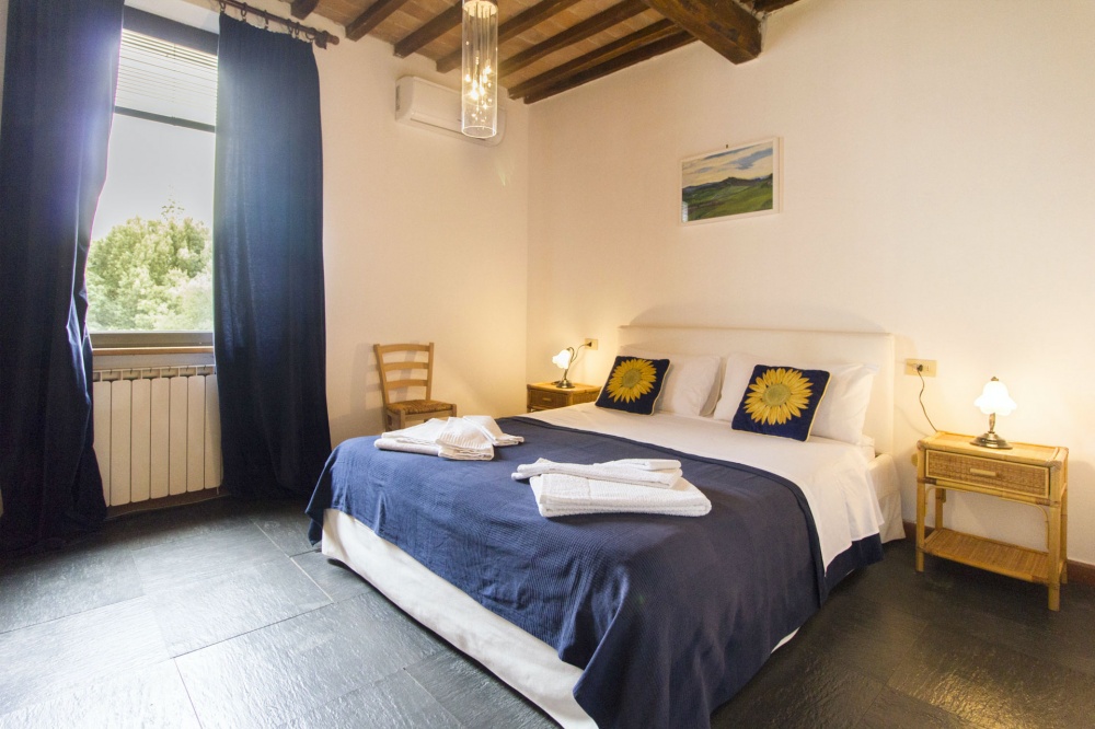 bedroom of an apartment for guests at the romantic farmhouse near siena
