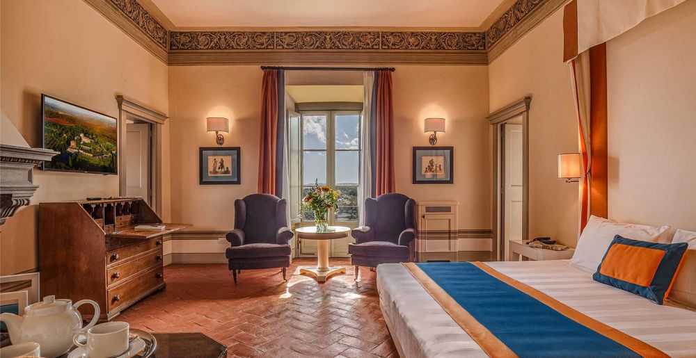 Blue and orange bedroom at luxury wedding hamlet in Tuscany