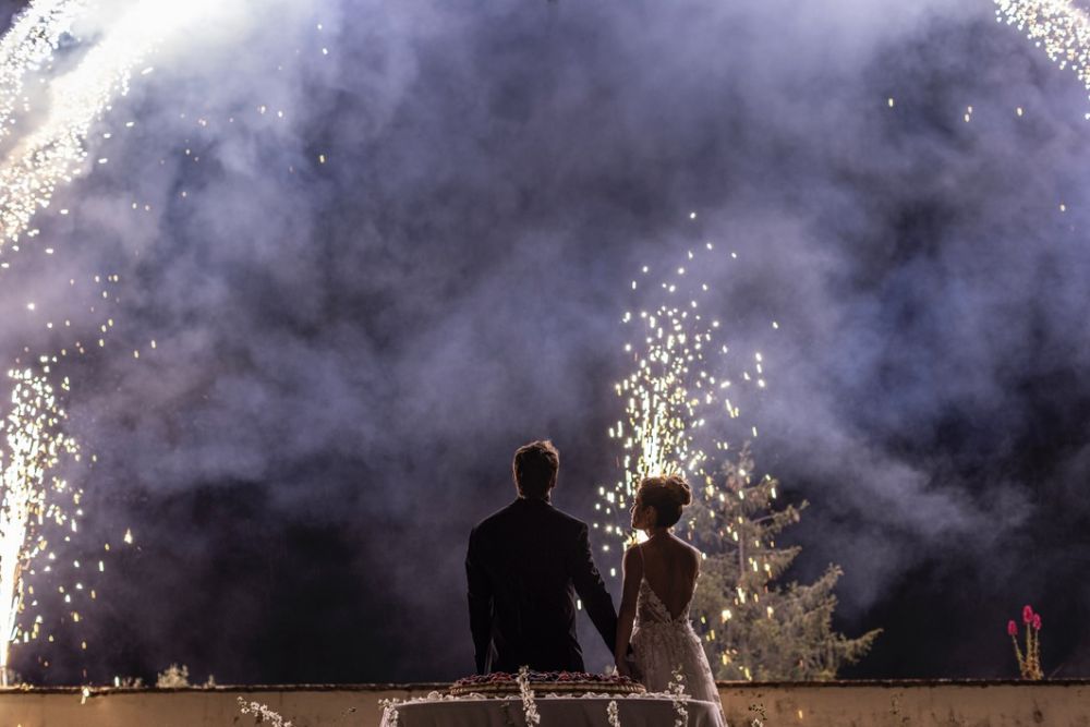 Bride and groom looking at fireworks at wedding villa in Florence with view