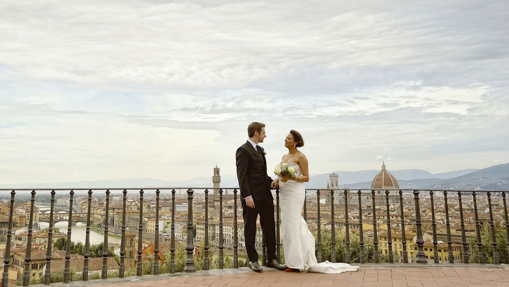 Bride and groom on the balcony with Florence view