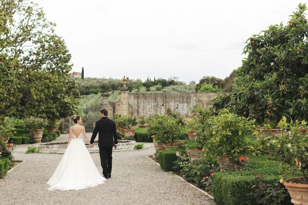 Bride and groom in the Italian garden at wedding villa in Florence with view