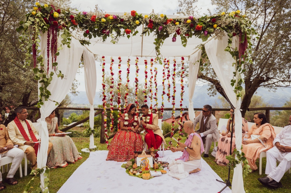 Bride and groom under mandap of luxury venue in Lucca