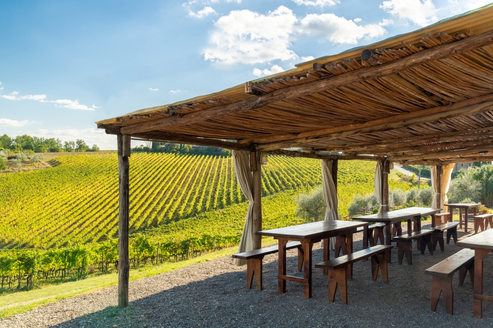 Covered arbour with view at wedding farmhouse in Tuscany