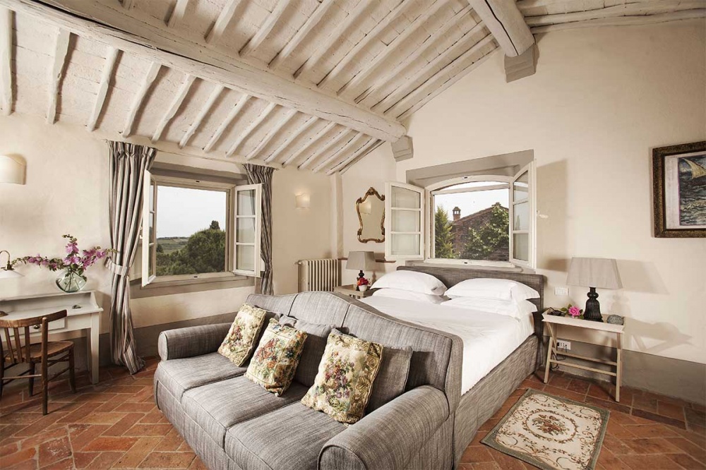 Elegant bedroom with cute windows at hamlet for weddings near Siena