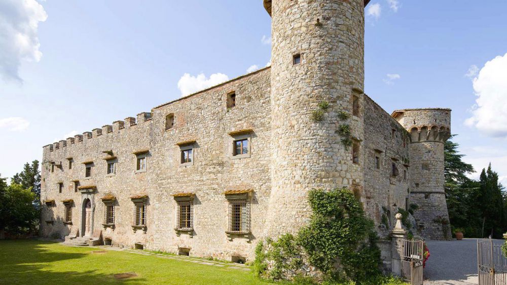 Garden and facade of the Medieval castle in Tuscany