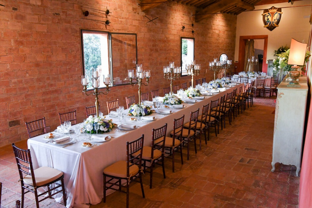 indoor wedding dinner with long table and candelabras