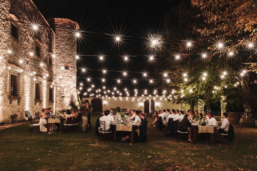 wedding dinner with bulblights in a medieval castle in chianti tuscany