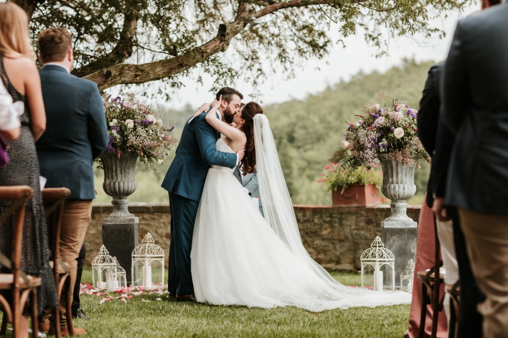 outdoor ceremony in tuscany in a garden with flower pots