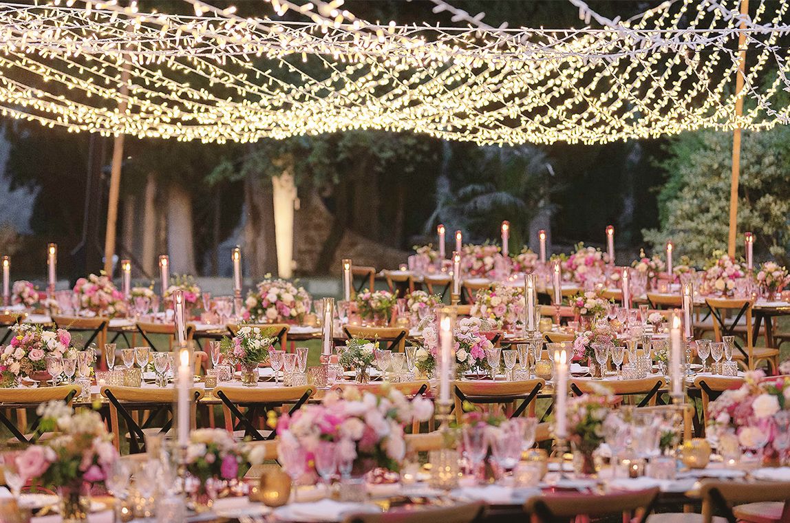 Pink table with bulb lights at the Tuscan wedding