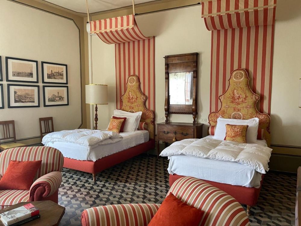 Red and gold bedroom at the villa for wedding in Tuscany