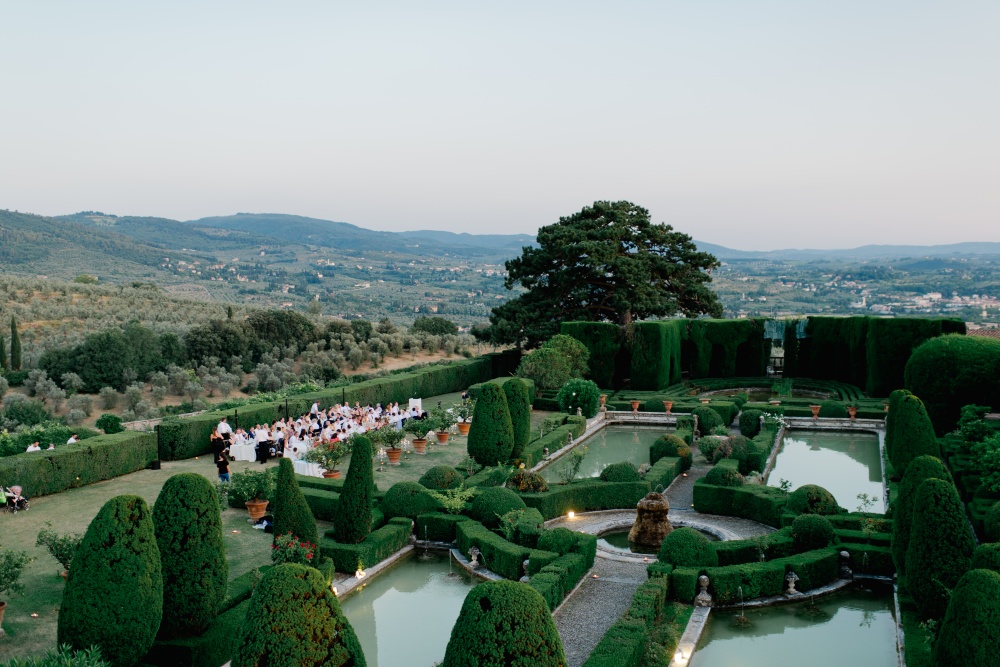 tuscan wedding villa with a dinner setting next to the italian garden