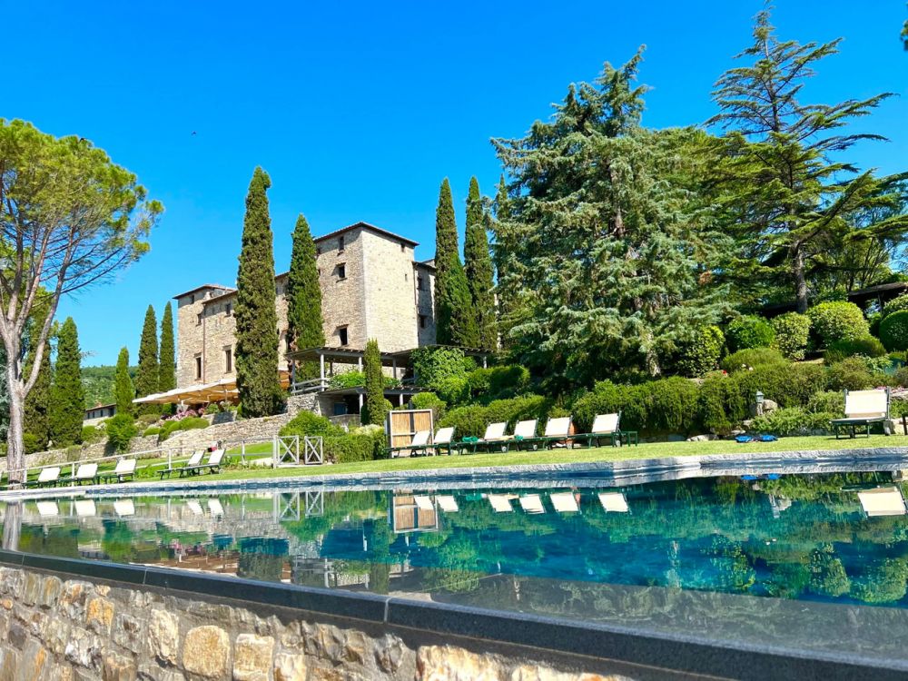 View of the facade by the pool at wedding castle in Siena