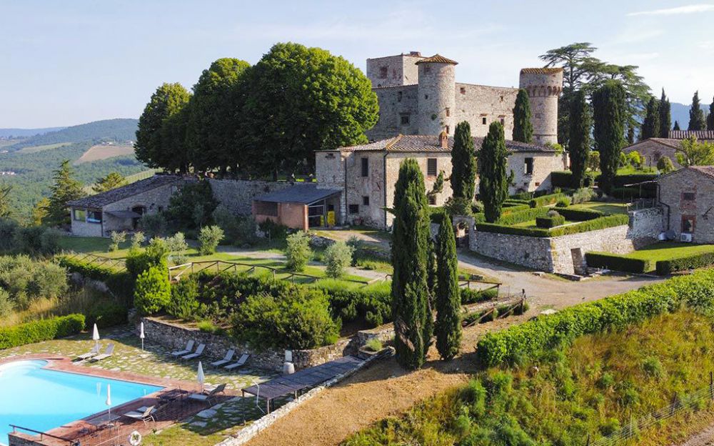 View of pool and Medieval castle in Tuscany