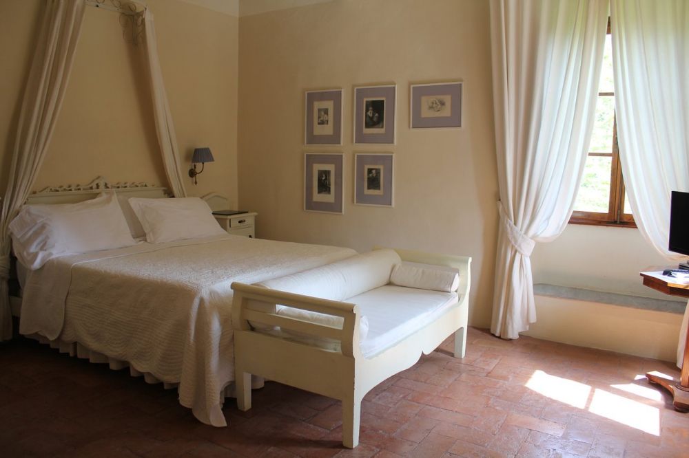 White bedroom of the vila for wedding in Tuscany