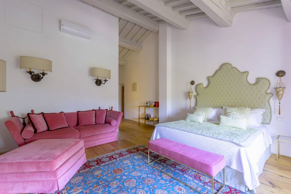 White and pink bedroom of the Medieval castle in Tuscany