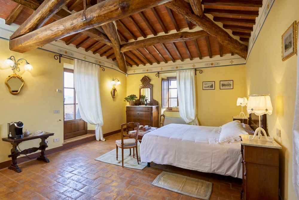 Yellow wooden bedroom at the villa for weddings in Siena